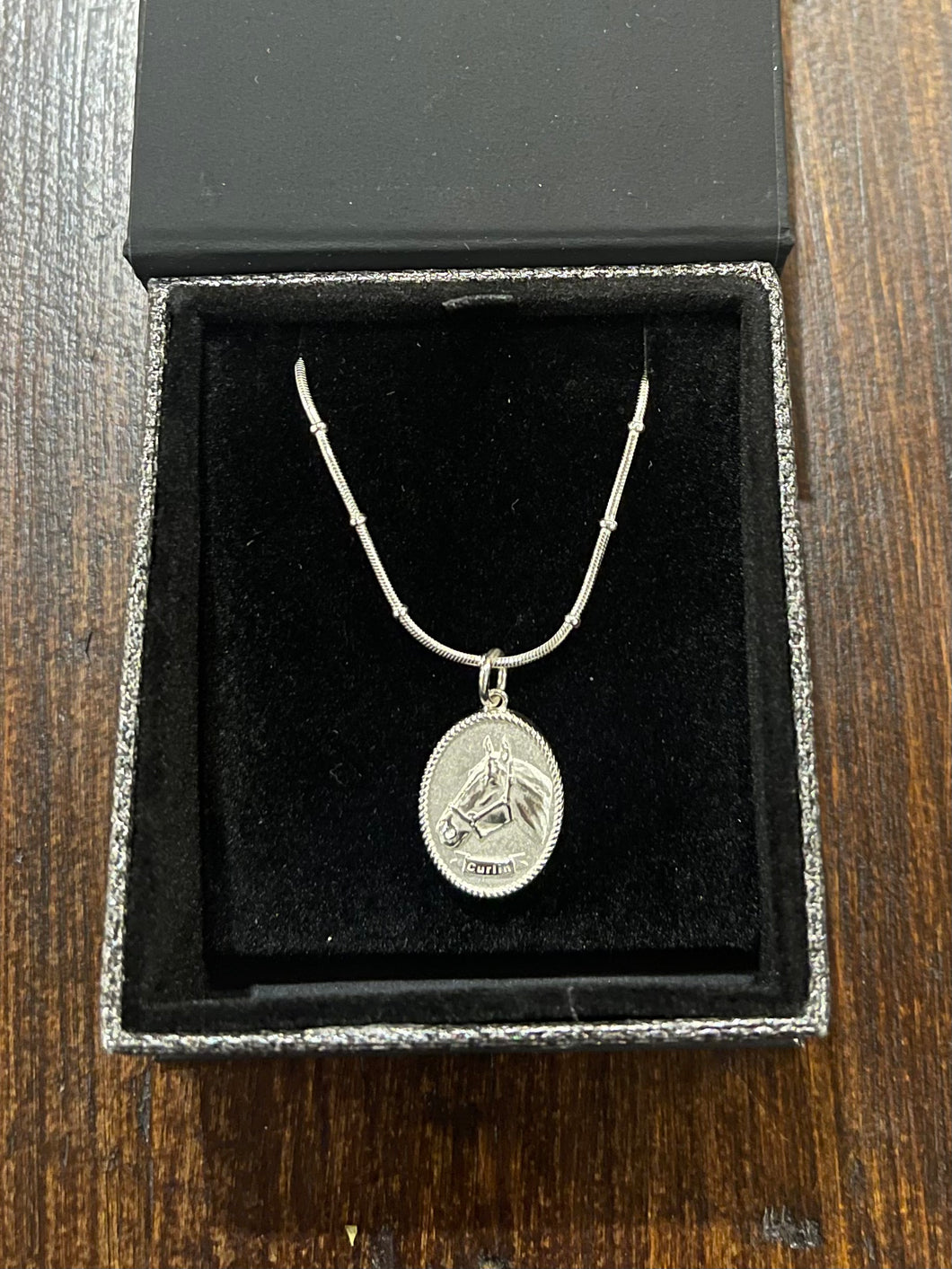 SJC-Small Curlin charm on 14” or 16” chain. Sterling silver
