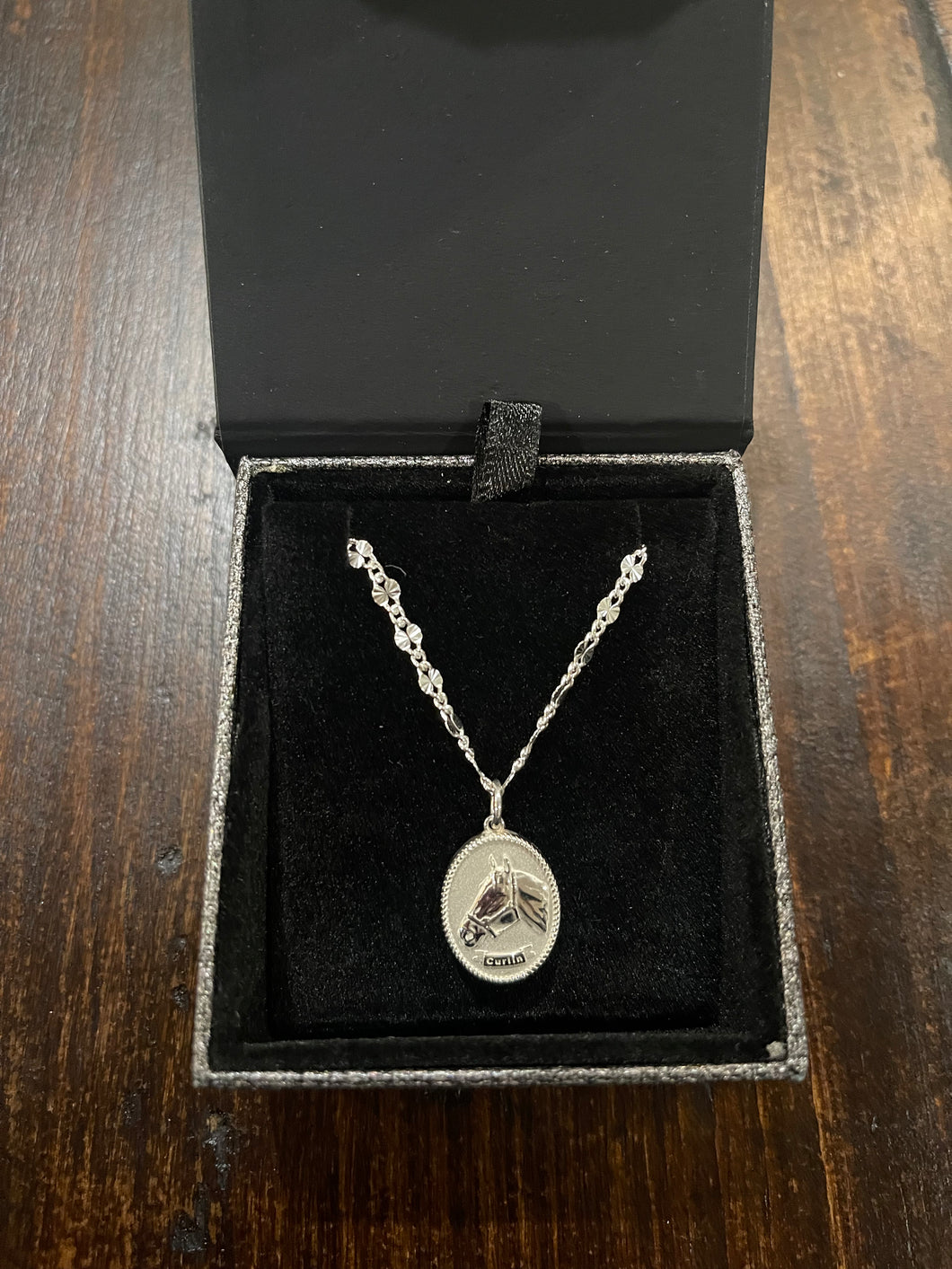 SJC-Small Curlin charm on 14” or 16” chain. Sterling silver.